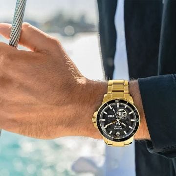 Photo of the Bulova Marine Star 97A174 automatic watch with a black skeleton dial, stainless steel and yellow gold PVD case