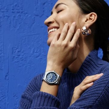 Photo of the Citizen Zenshin Super Titanium 39mm watch AW0130-85L featuring a sleek blue dial, durable Super Titanium case and bracelet, and Eco-Drive technology.