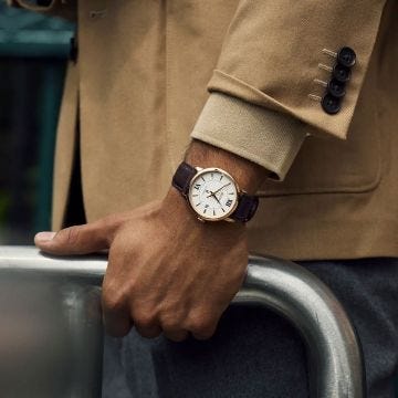 Photo of the Bulova Hudson 97B225 men's watch with a sophisticated white dial, rose gold PVD case, and leather strap
