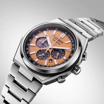 Photo of the Citizen Zenshin Super Titanium 42mm watch CA4610-85Z with vibrant orange dial, lightweight titanium case, and Eco-Drive technology. A bold yet lightweight timepiece
