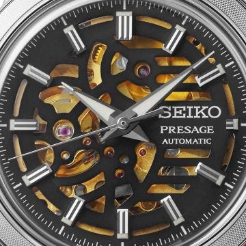 Photo of the Seiko Presage Style 60s 39.5mm watch (SSA461J1) with a grey skeleton dial, automatic movement, stainless steel case, and leather strap