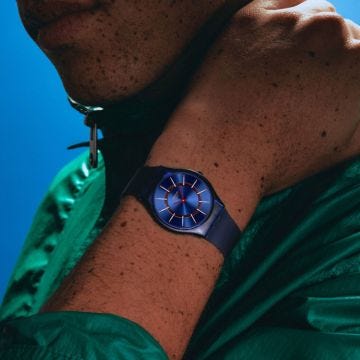 Photo of the Swatch Very Jazzy Berry 34mm blue dial quartz watch with gradient silicone strap, model SS08N117