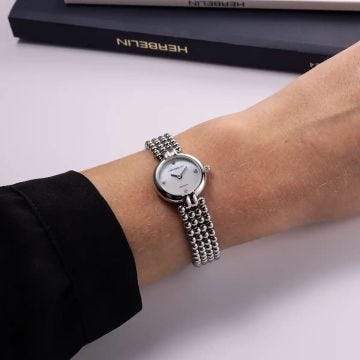 Photo of the Herbelin Perles 22mm Mother of Pearl Diamond Dial Quartz Watch 17433B89, featuring a luminous MOP dial set with diamond hour markers and a polished stainless steel bracelet
